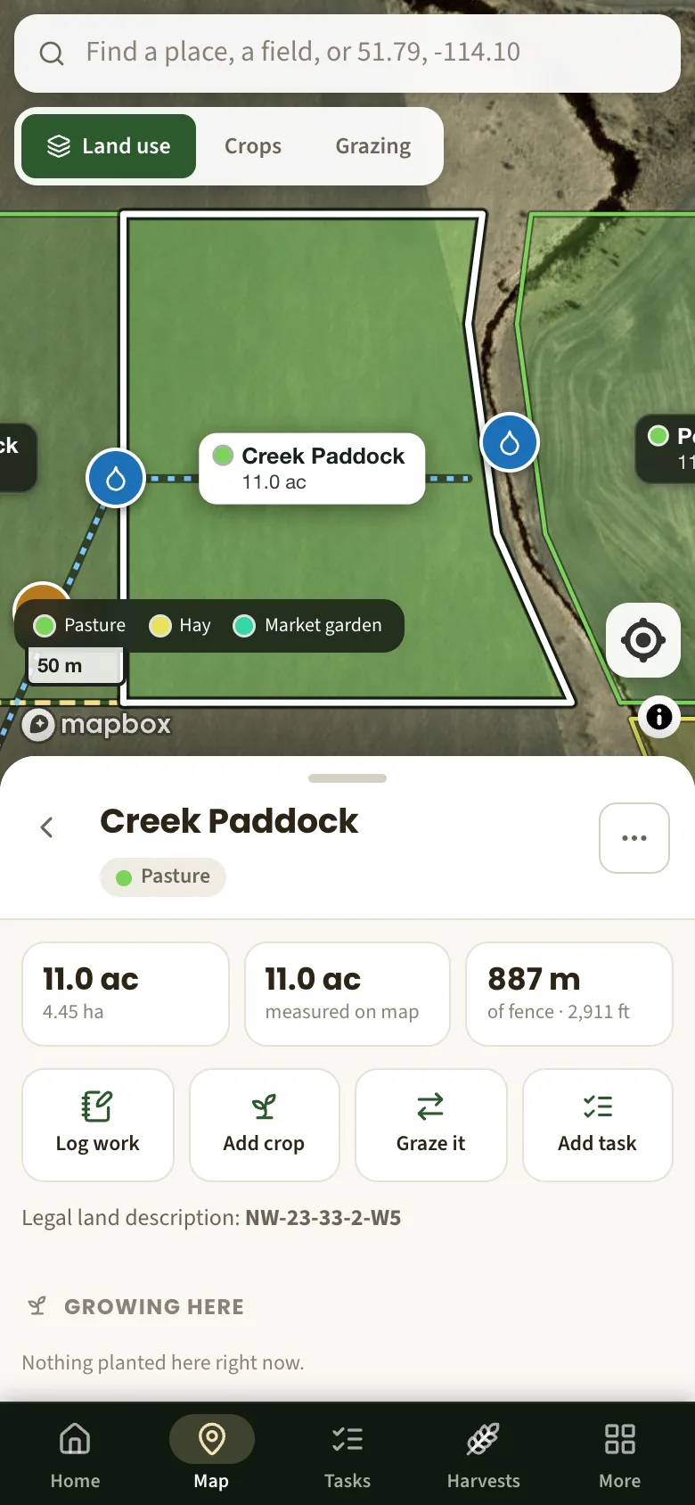 The farm map on a phone, with one paddock selected and its acres and fence length below